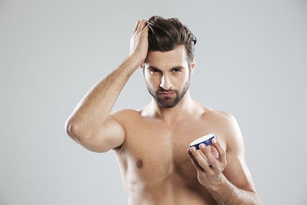Homme appliquant de la crème capillaire sur ses cheveux , Gel capillaire et chute de cheveux