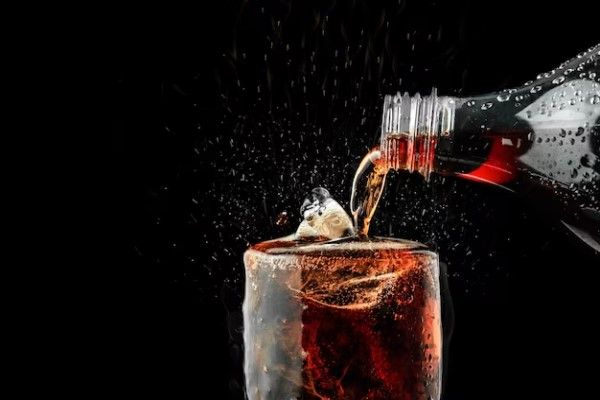verre de soda pétillant sur fond noir
