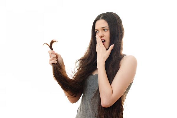 Une jeune femme est surprise par ses cheveux fourchus